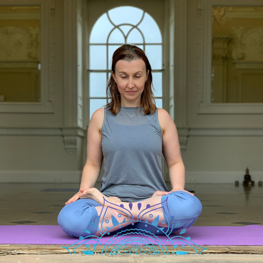Yoga teacher seated in lotus position